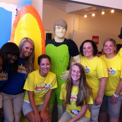 A group of people wearing yellow and blue shirts