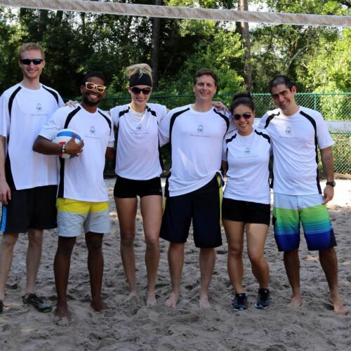 A group of people playing volleyball